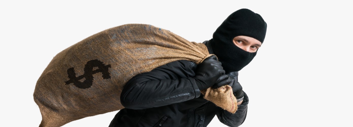 Masked thief with burlap bag of money