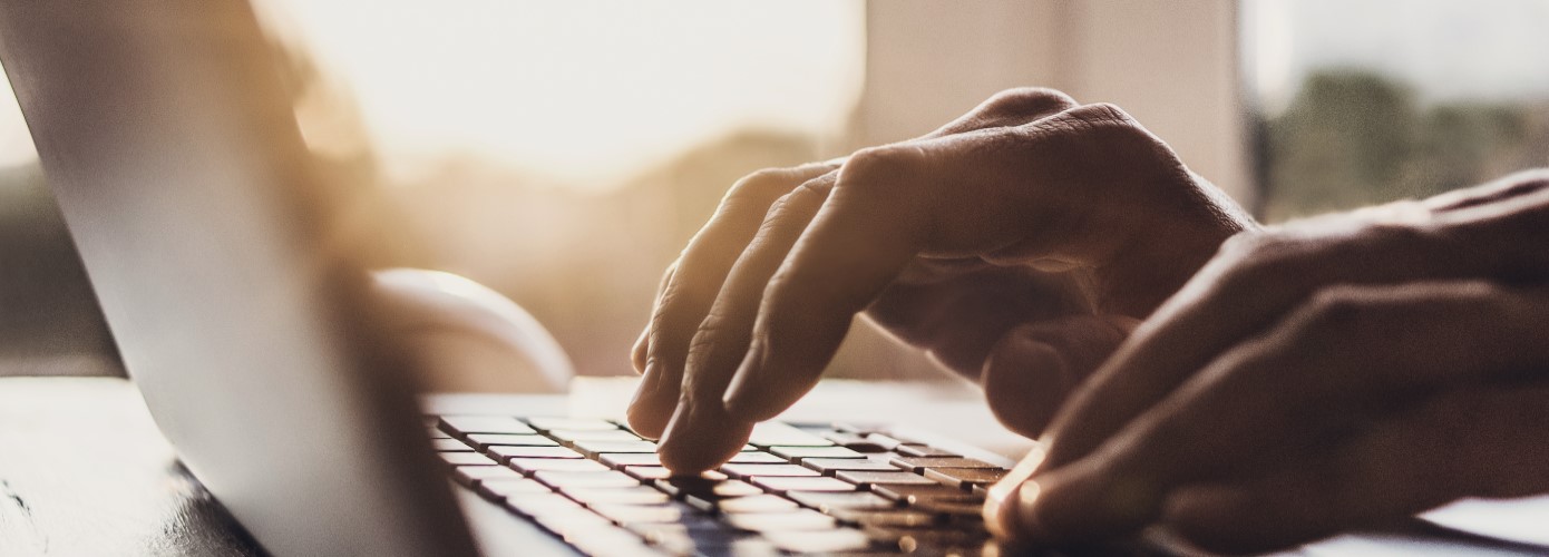 Man's hands on laptop keyboard